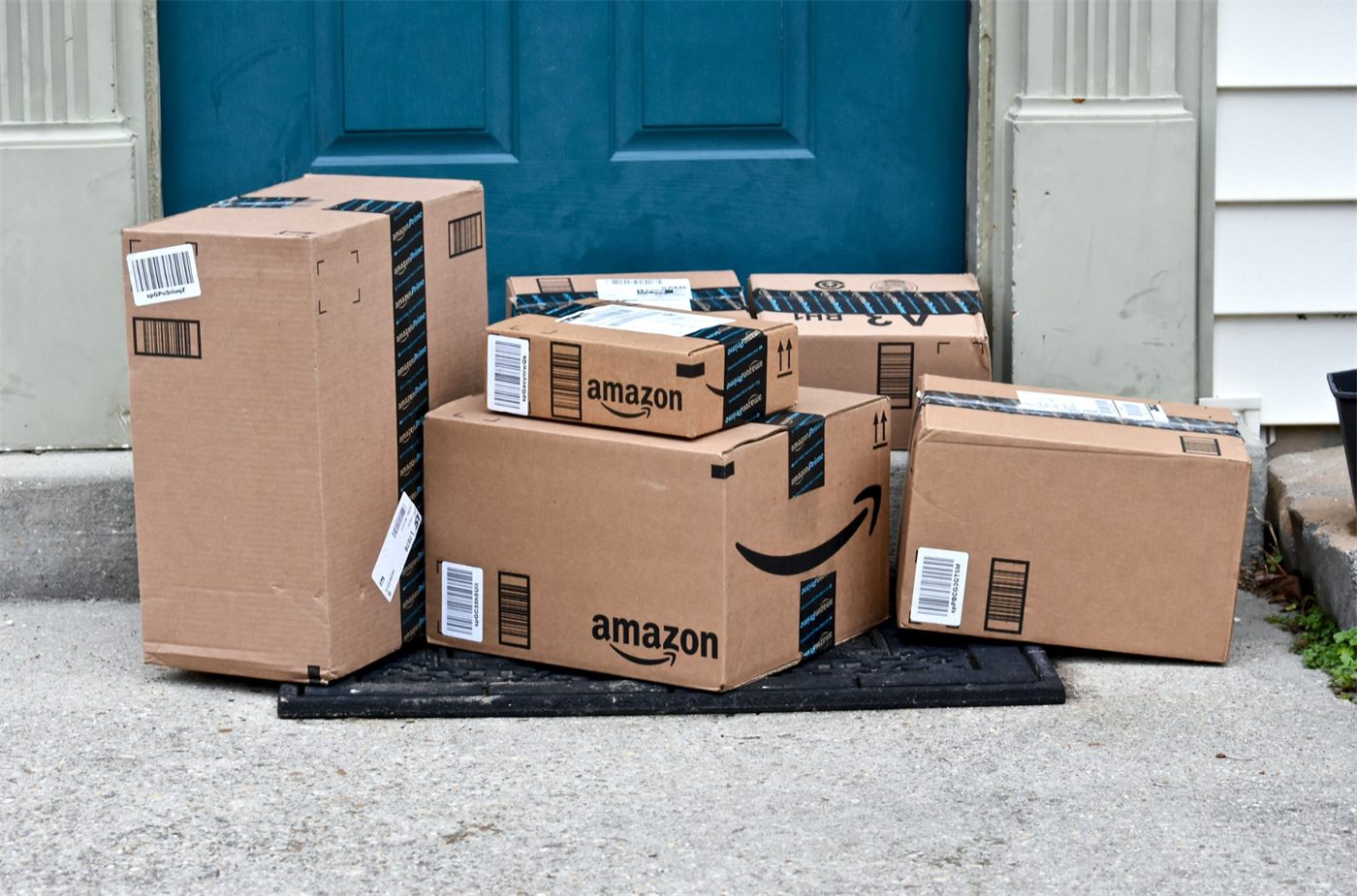 Several cardboard parcels stacked on a front doorstep