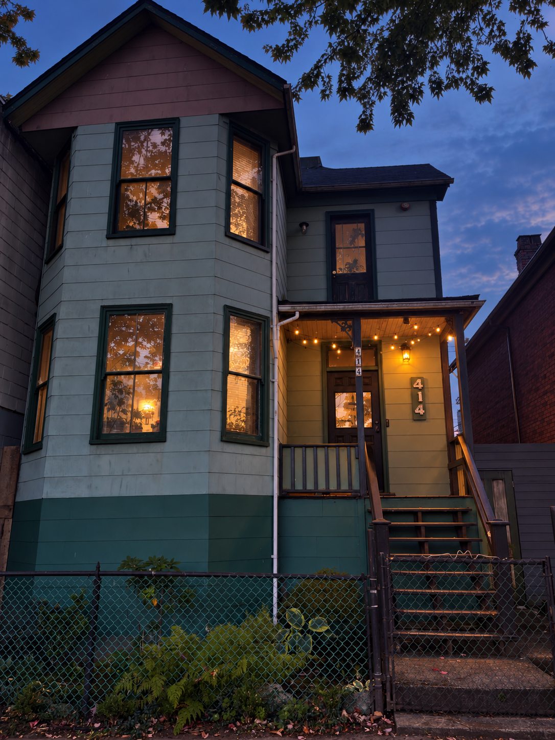 414 East Cordova at dusk with the porch light on and warm light in every window