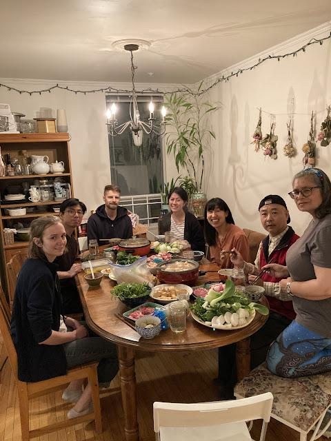 Friends gathered around a table sharing hotpot